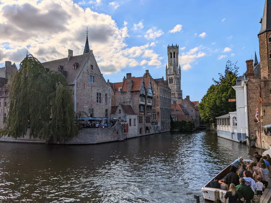 The Belfry of Bruges, seen from a distance across a canal