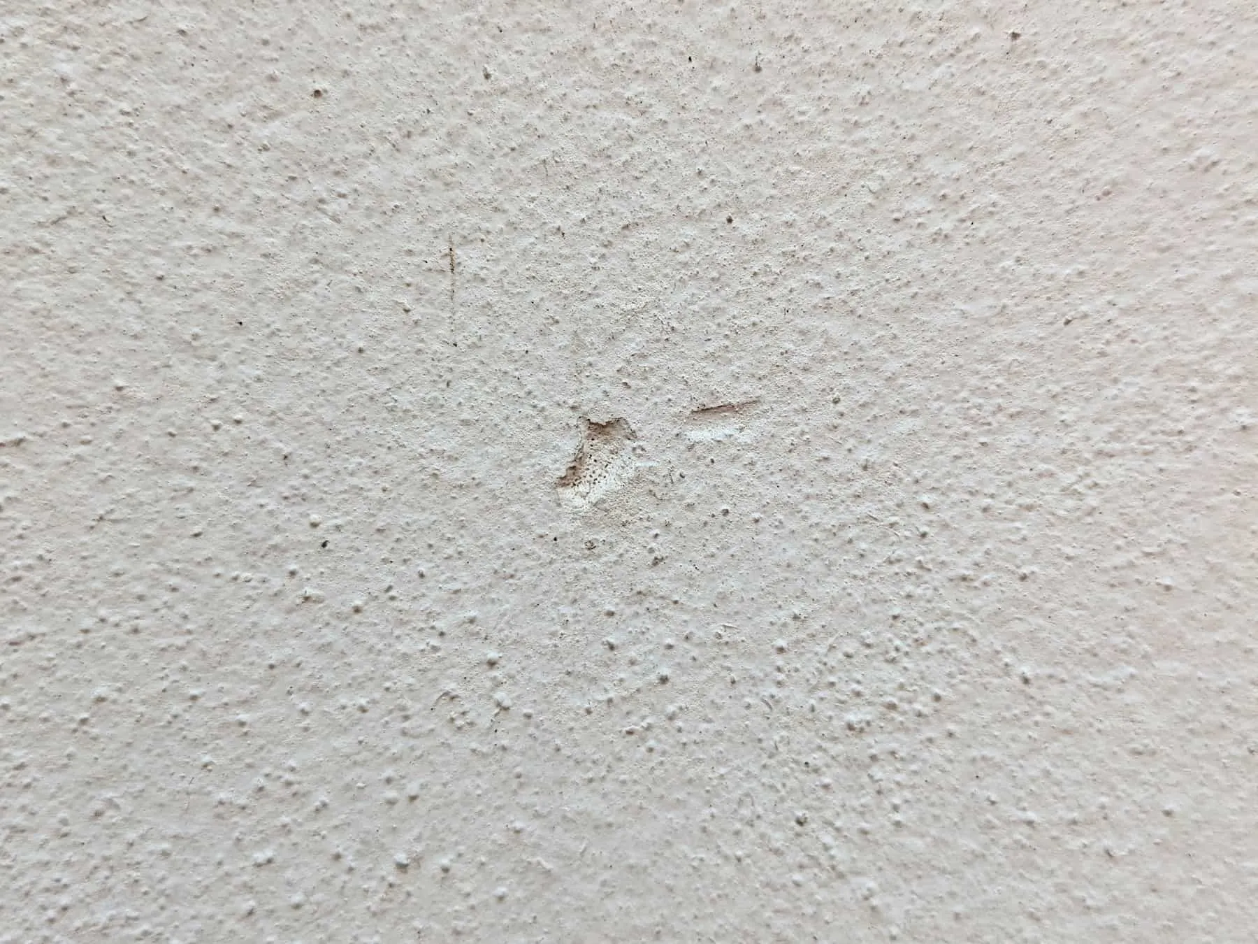 Mark I left on the wall after hitting it with the corner of my glasses